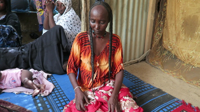 Woman showing stronger and longer hair after using chebe powder hair treatment