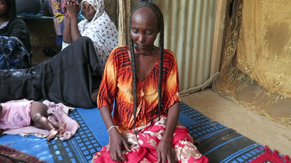 Woman showing stronger and longer hair after using chebe powder hair treatment